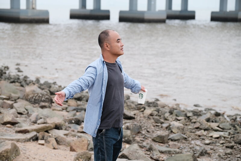 Standing by shore with Starbucks, approachable